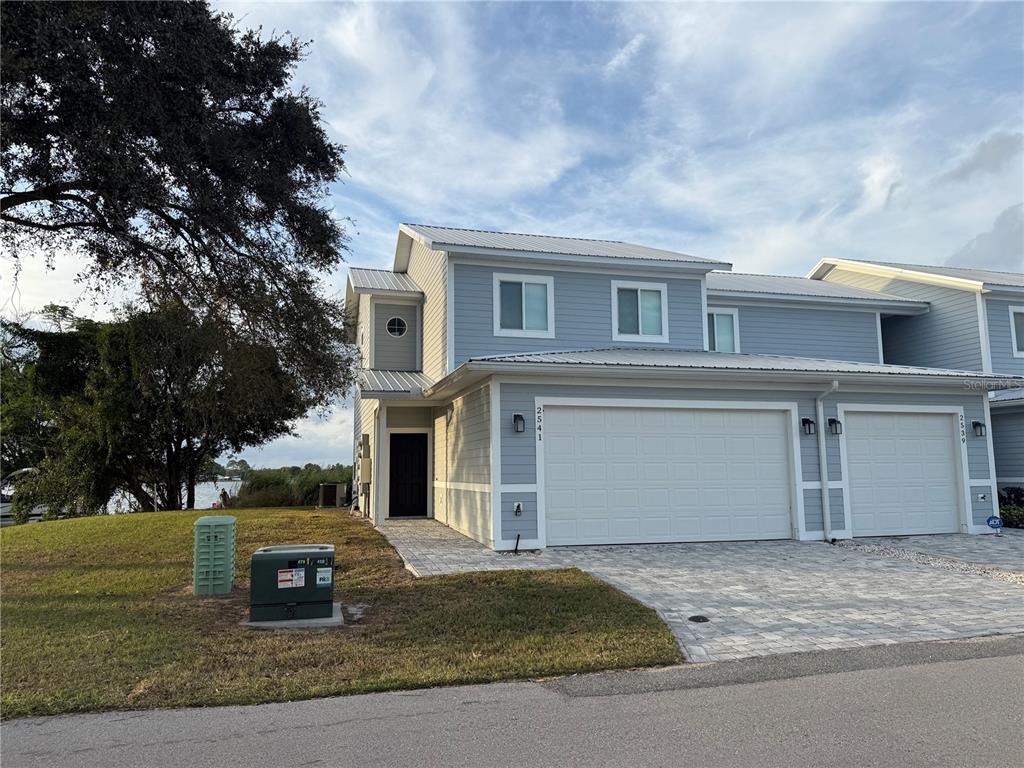 2541 Pine Place Winter Haven, FL 33881 - Photo 2 of 34 a view of a white house with a yard