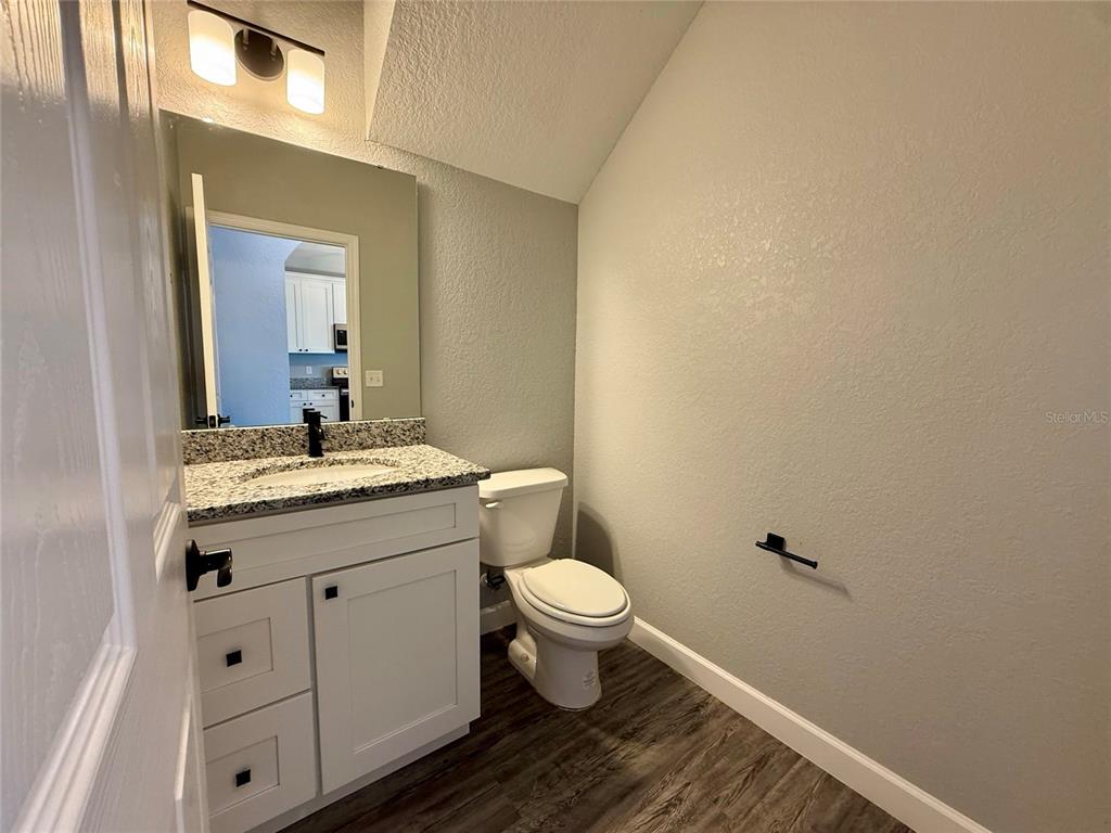 2541 Pine Place Winter Haven, FL 33881 - Photo 22 of 34 a bathroom with a toilet sink and mirror