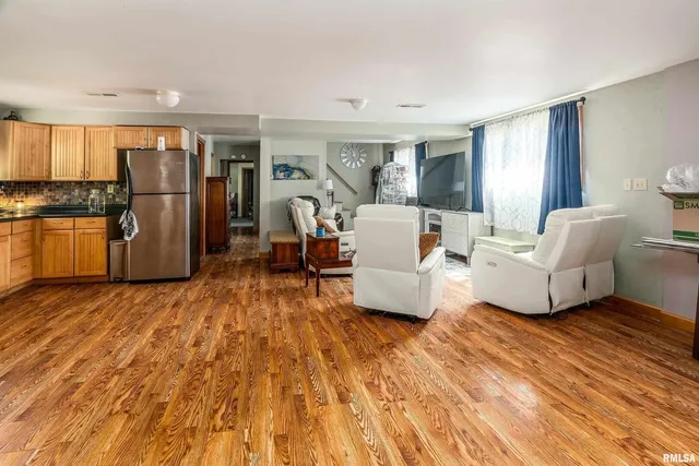 a very nice looking living room with a large window and wooden floor
