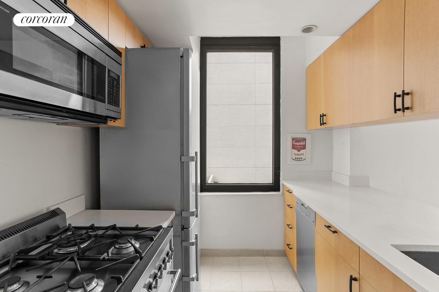 52 East End Avenue, Unit 8B Manhattan, NY 10028 - Photo 3 of 9 a kitchen with a stove and a refrigerator
