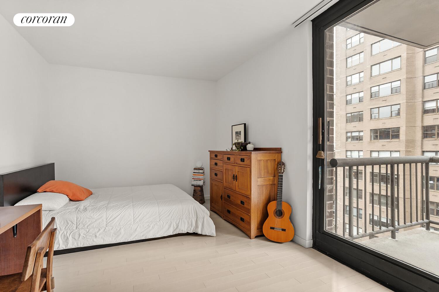 52 East End Avenue, Unit 8B Manhattan, NY 10028 - Photo 4 of 9 a bedroom with a bed and a large window