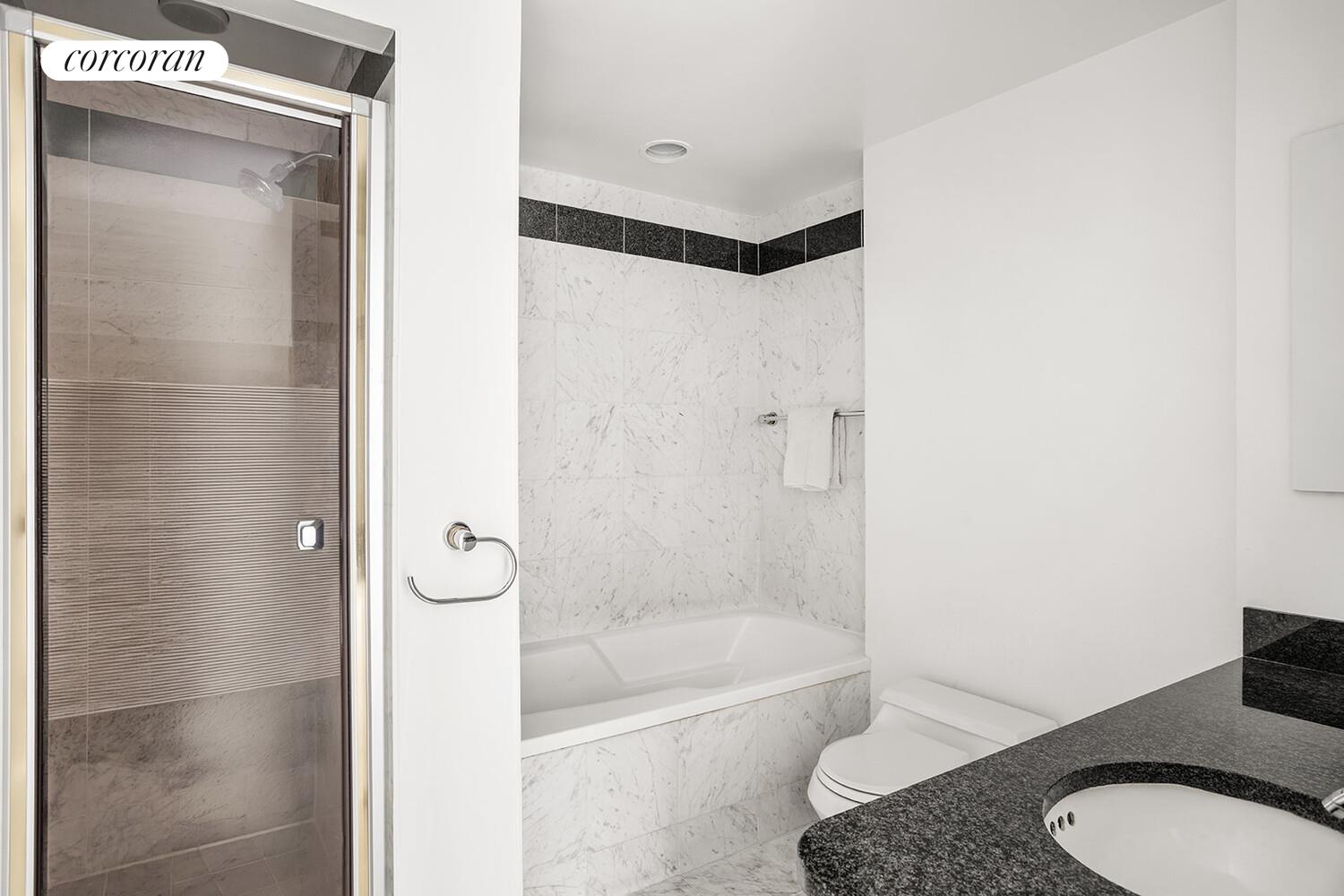 52 East End Avenue, Unit 8B Manhattan, NY 10028 - Photo 5 of 9 a bathroom with a granite countertop bathtub shower and toilet