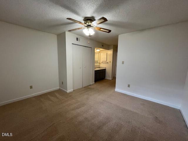 2516 Avent Ferry Road, Unit 102 Raleigh, NC 27606 - Photo 14 of 15 an empty room with chandelier fan and windows