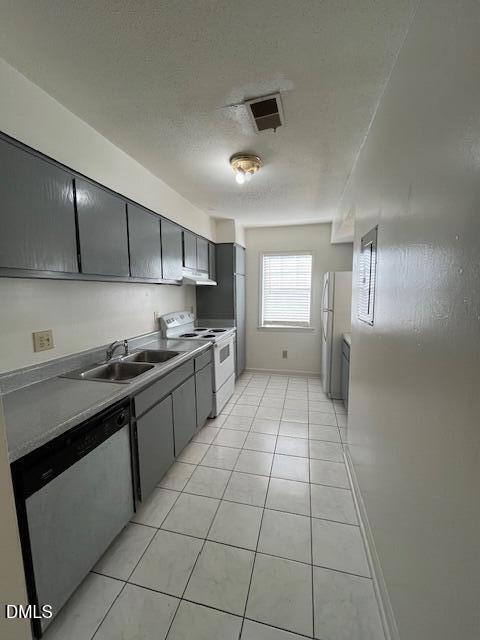 2516 Avent Ferry Road, Unit 102 Raleigh, NC 27606 - Photo 3 of 15 a kitchen with stainless steel appliances granite countertop a stove a sink and a refrigerator
