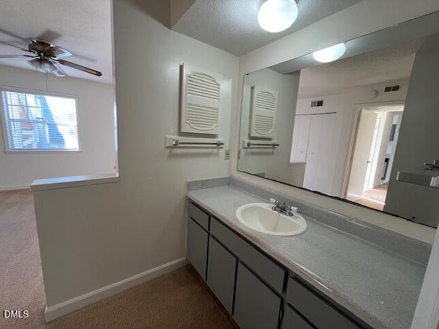 2516 Avent Ferry Road, Unit 102 Raleigh, NC 27606 - Photo 8 of 15 a bathroom with a granite countertop sink a toilet and a mirror