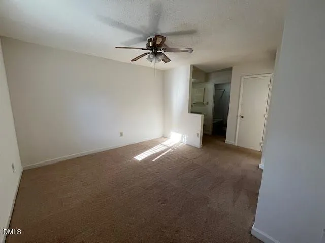 a view of a livingroom with a ceiling fan and window