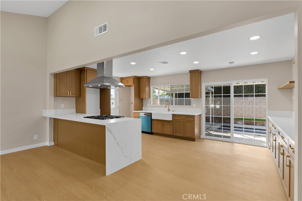 a kitchen with stainless steel appliances a stove a sink a refrigerator and cabinets