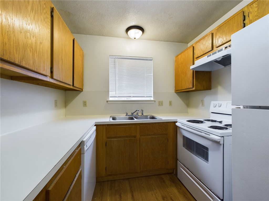 1221 April Bloom, Unit AB College Station, TX 77840 - Photo 11 of 31 a kitchen with a sink a stove and cabinets