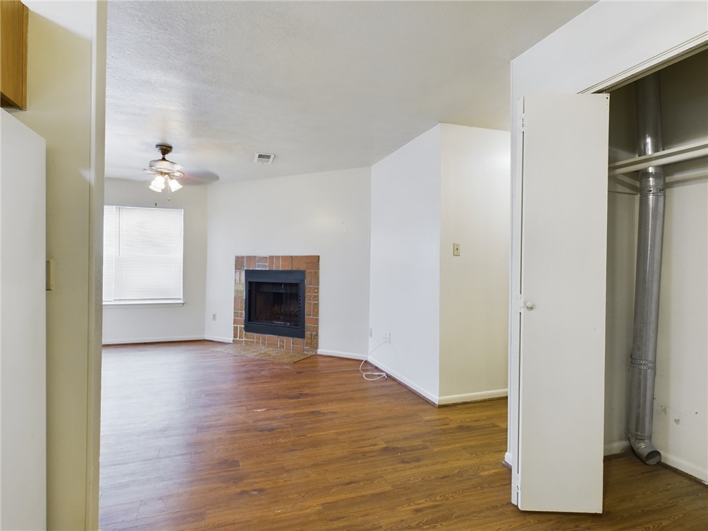 1221 April Bloom, Unit AB College Station, TX 77840 - Photo 13 of 31 a view of an empty room with wooden floor and a fireplace