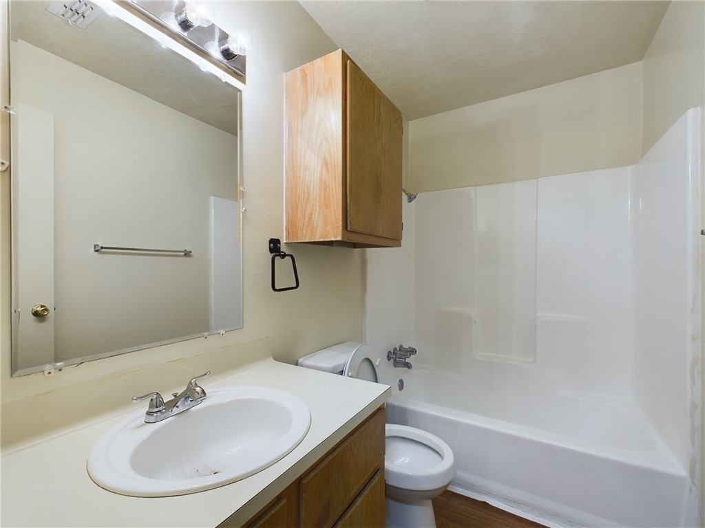 1221 April Bloom, Unit AB College Station, TX 77840 - Photo 16 of 31 a bathroom with a sink toilet and a mirror