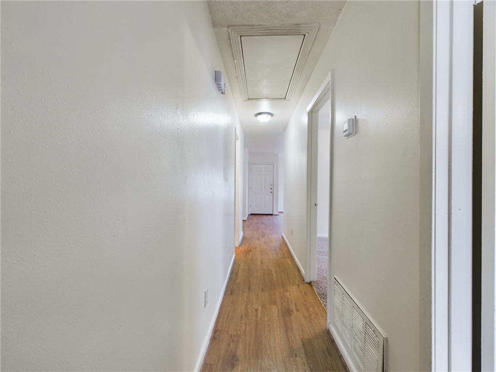 1221 April Bloom, Unit AB College Station, TX 77840 - Photo 19 of 31 a view of a hallway with wooden floor