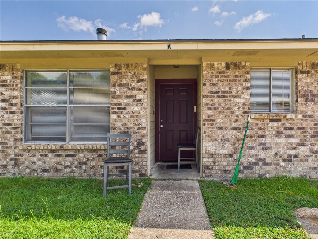1221 April Bloom, Unit AB College Station, TX 77840 - Photo 2 of 31 a front view of a house with a garden