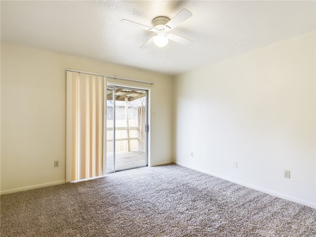 1221 April Bloom, Unit AB College Station, TX 77840 - Photo 22 of 31 an empty room with a window and a ceiling fan