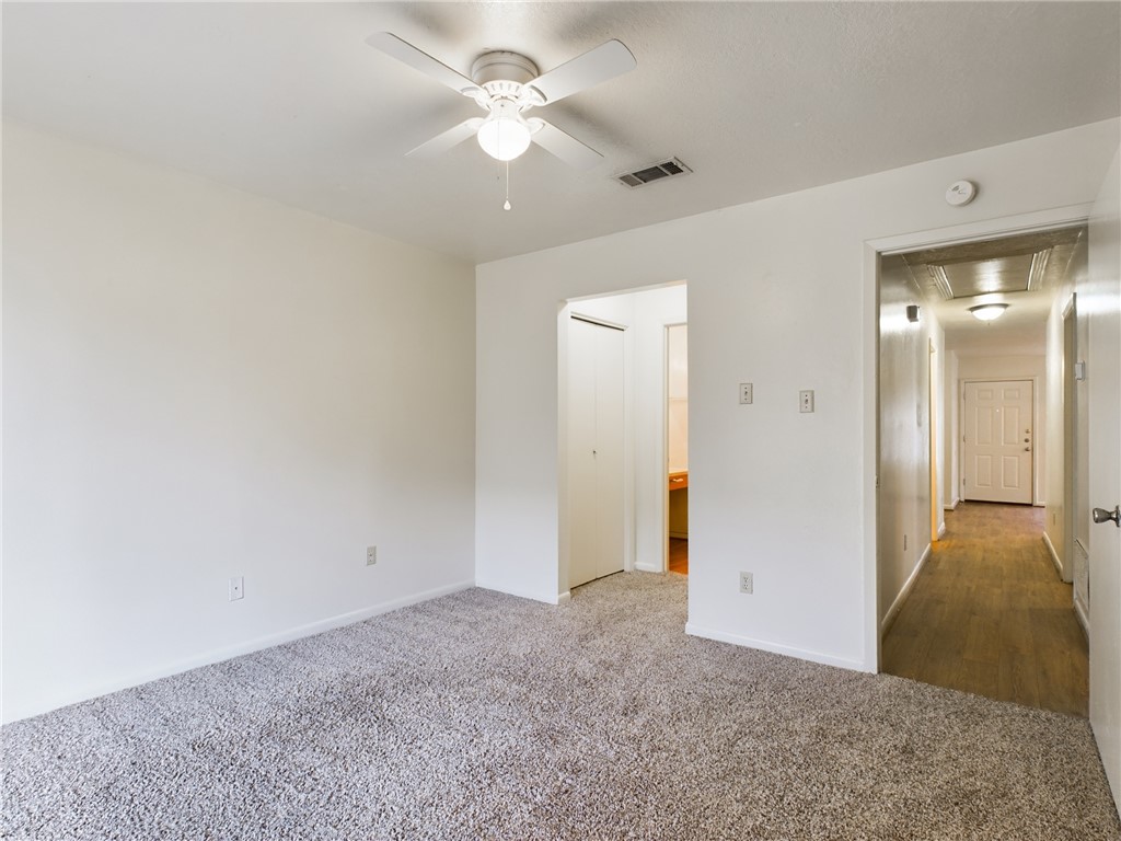 1221 April Bloom, Unit AB College Station, TX 77840 - Photo 23 of 31 an empty room with fan and entrance