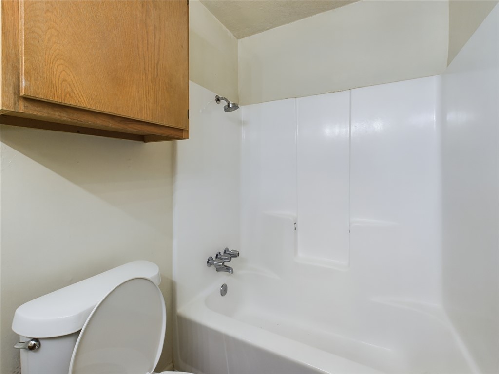 1221 April Bloom, Unit AB College Station, TX 77840 - Photo 26 of 31 a bathroom with a toilet and a bathtub