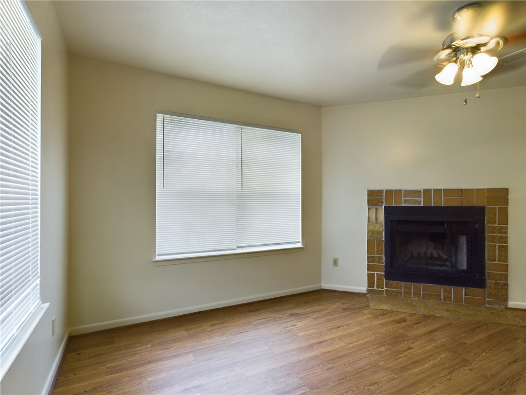1221 April Bloom, Unit AB College Station, TX 77840 - Photo 4 of 31 an empty room with wooden floor fireplace and windows