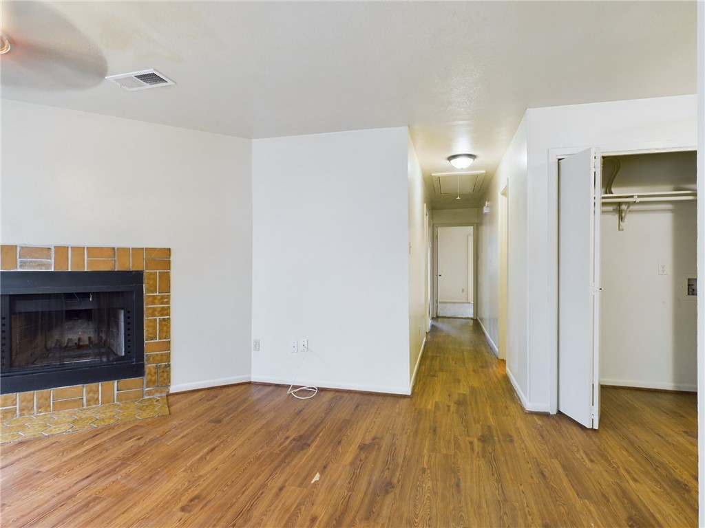 1221 April Bloom, Unit AB College Station, TX 77840 - Photo 6 of 31 a view of empty room with wooden floor and fireplace