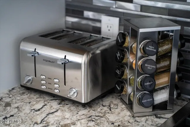 a bathroom with a granite countertop sink a shower a mirror and a shower