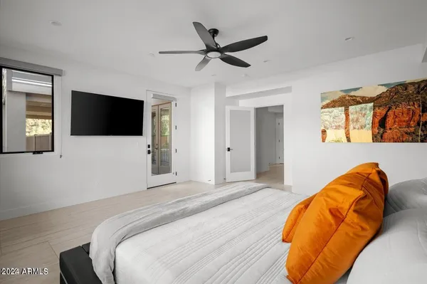 a bedroom with a bed and a flat screen tv