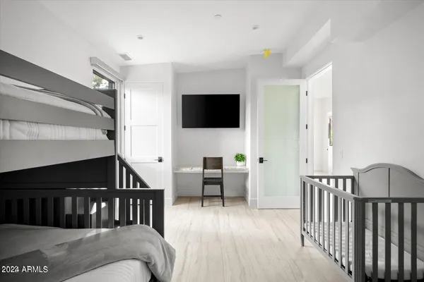 a bedroom with a bed and a painting on the wall