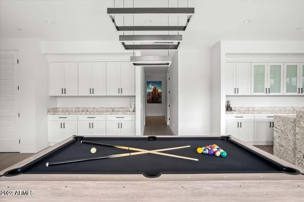 a bedroom with a bed and painting on the wall