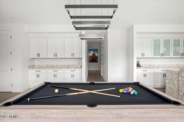 a bedroom with a bed and painting on the wall