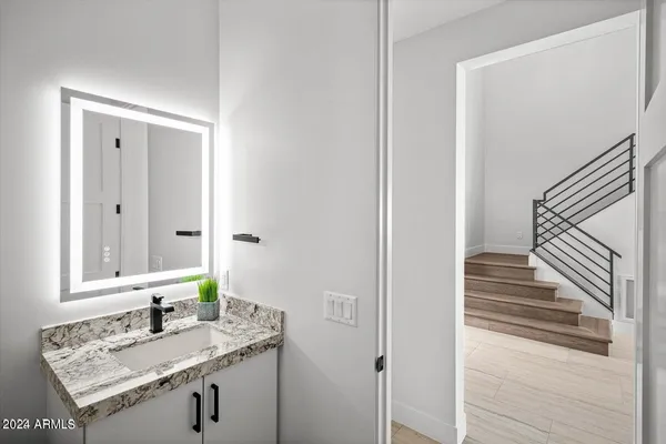 a kitchen with stainless steel appliances kitchen island granite countertop a table chairs sink and cabinets