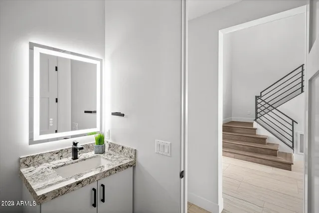 a kitchen with stainless steel appliances kitchen island granite countertop a table chairs sink and cabinets