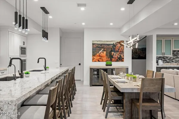 a stove sitting inside of a kitchen with white cabinets