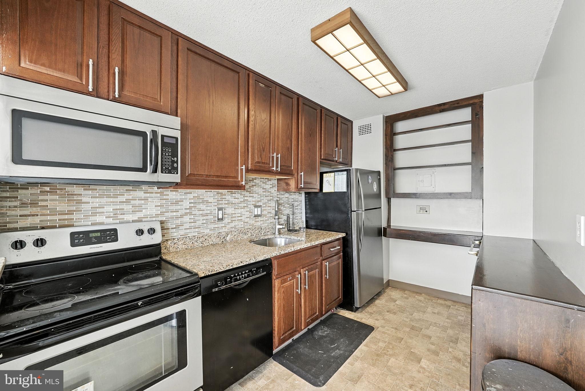 2059 Huntington Avenue, Unit 503 Alexandria, VA 22303 - Photo 7 of 22 a kitchen with a stove microwave and sink