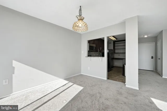 an empty room with windows and ceiling fan