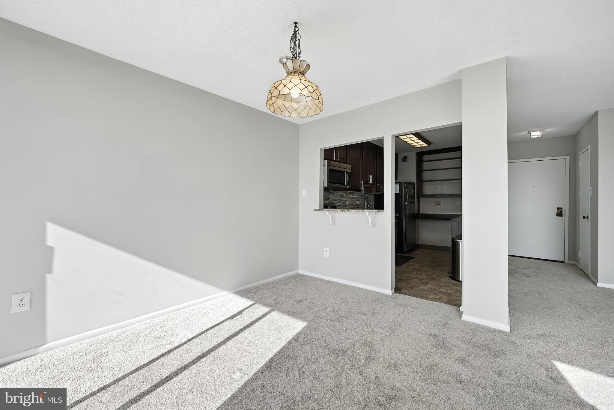 2059 Huntington Avenue, Unit 503 Alexandria, VA 22303 - Photo 10 of 22 an empty room with windows and ceiling fan