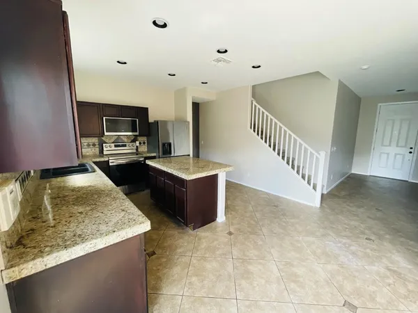 a view of kitchen and kitchen with sink