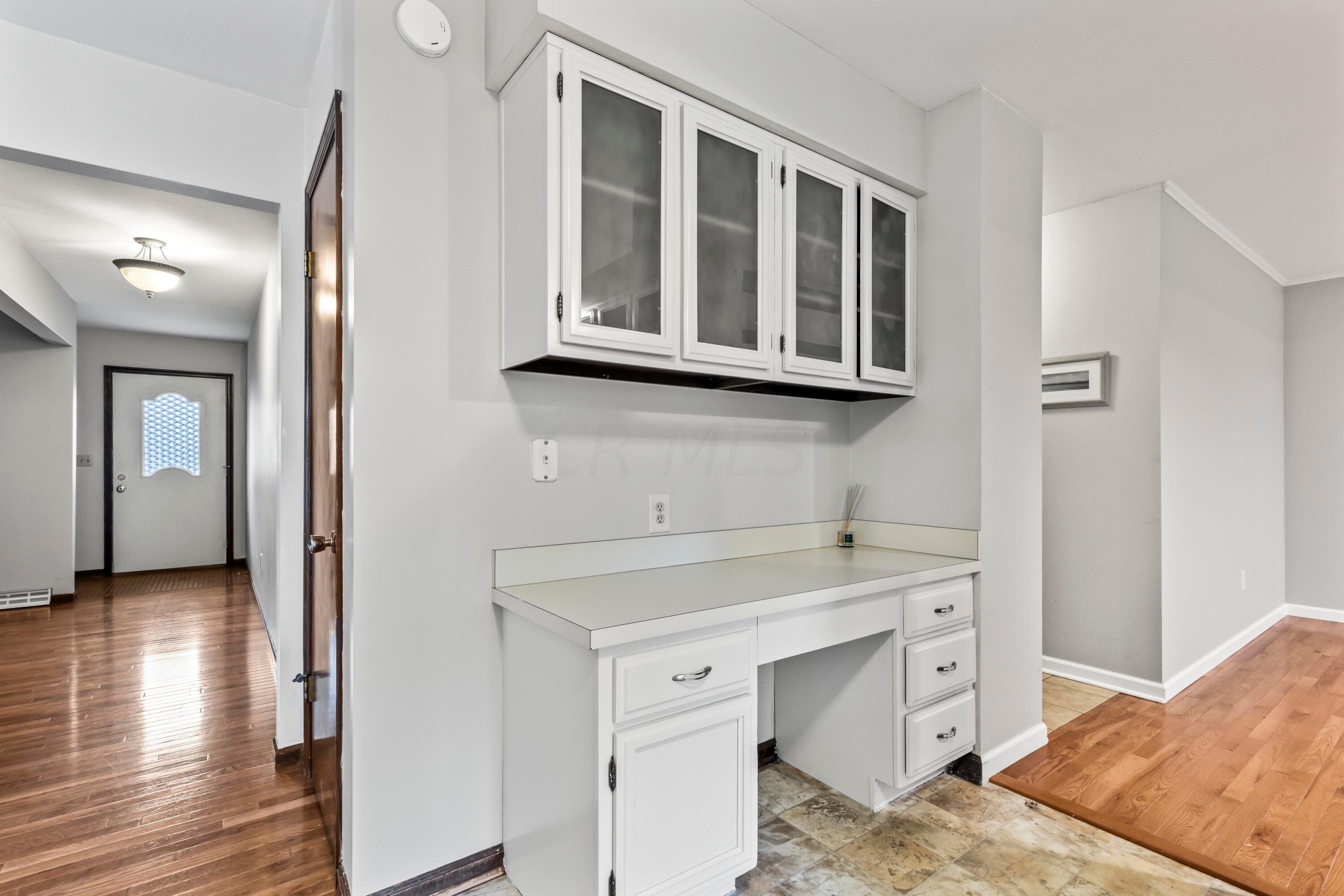 7020 Rieber Street Columbus, OH 43085 - Photo 13 of 40 • New neutral vinyl flooring ~ 2006 • Grey painted walls • Raised panel, white painted cabinets with glass fronts • New Whirlpool® refrigerator ~ 2017 • New Whirlpool® electric range ~ 2017 • Allure® rangehood • New Kenmore® dishwasher ~ 2017 • Double bowl, stainless steel sink with sprayer • New disposal • Can lighting • New sliding doors to screened porch • Planning desk • Buffet/media center • Pantry closet • Sliding doors to Screened Porch