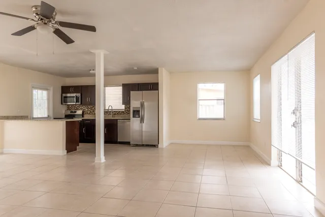 a view of a kitchen with a sink and a refrigerator