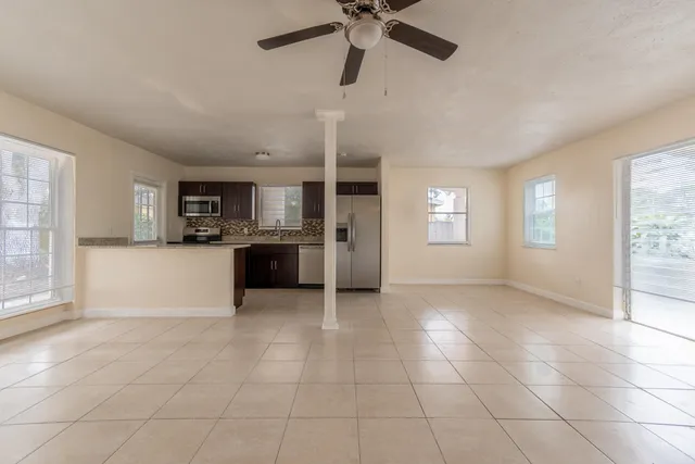 a view of a kitchen with a sink and a window