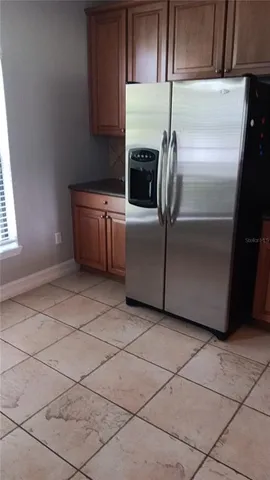 a kitchen with a refrigerator a stove a microwave and cabinets