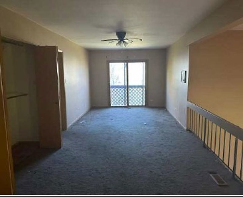 3710 Briar Lane Hazel Crest, IL 60429 - Photo 11 of 27 en empty room with windows and ceiling fan