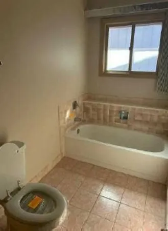 a bathroom with a bathtub and window