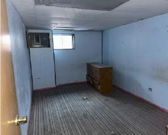 a room with wooden floor and window