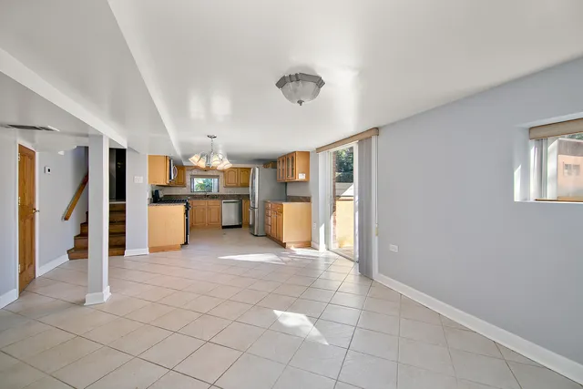 a view of a kitchen with a refrigerator and a window