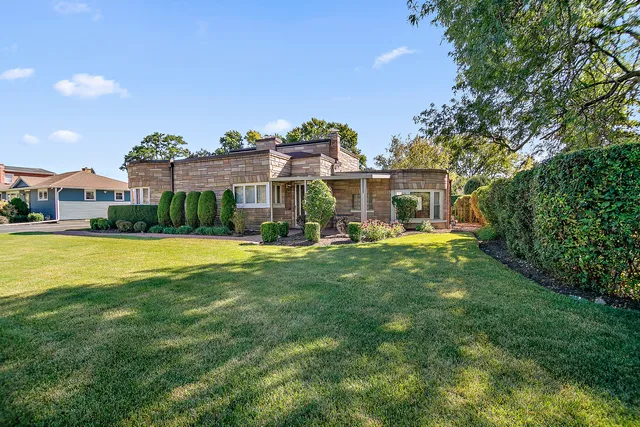 a view of house with a yard