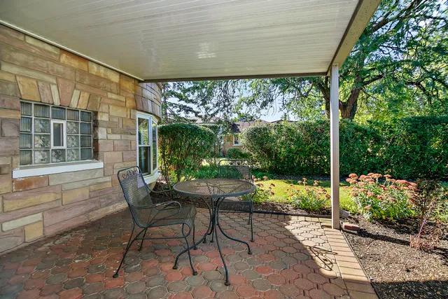 a view of a porch with chairs and backyard
