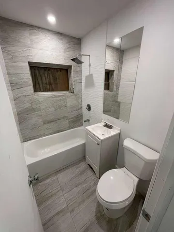 a bathroom with a toilet a sink and bathtub