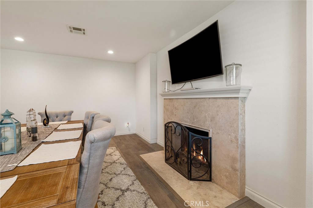 9434 Pico Vista Road Downey, CA 90240 - Photo 11 of 51 a living room with furniture a fireplace and a flat screen tv