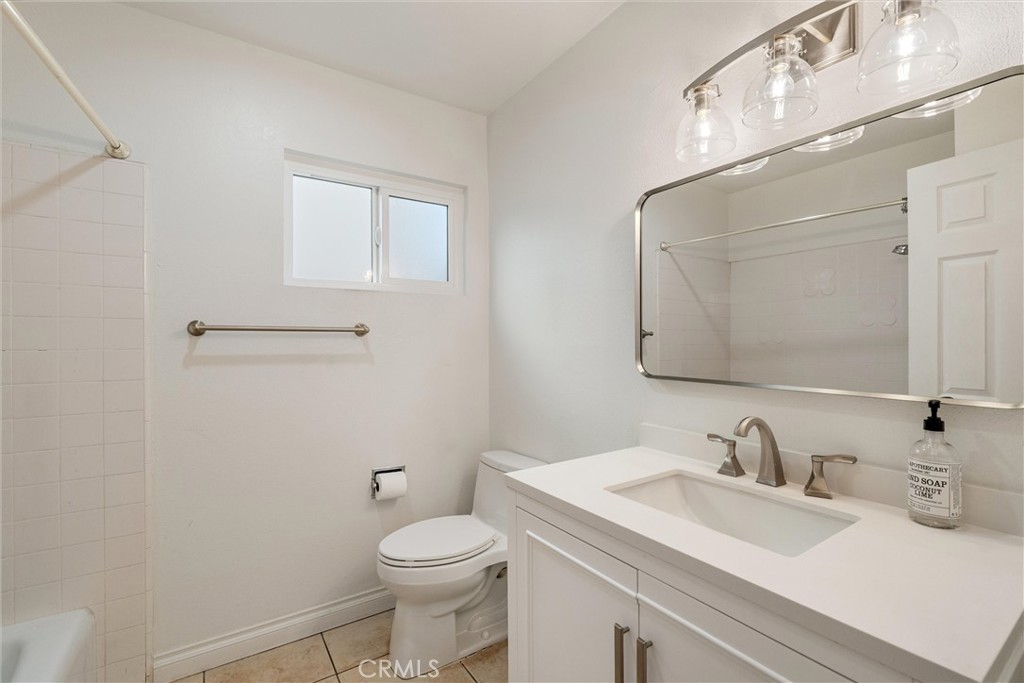 9434 Pico Vista Road Downey, CA 90240 - Photo 12 of 51 a bathroom with a sink a toilet and a mirror