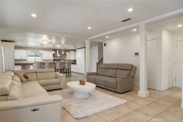 a kitchen with stainless steel appliances kitchen island granite countertop a table and chairs in it
