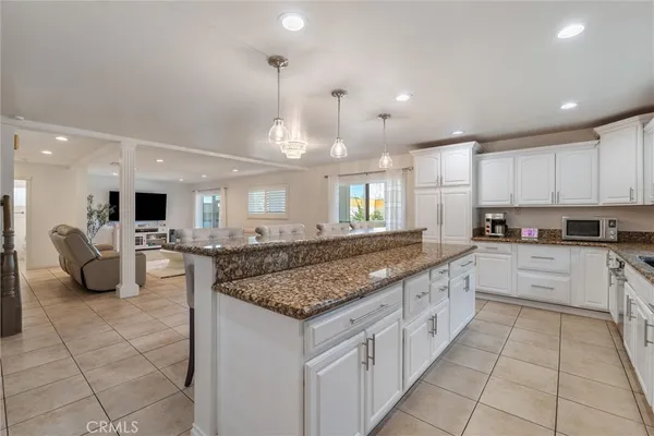 a kitchen with a stove and white cabinets
