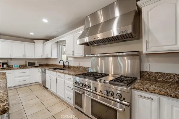 a kitchen with stainless steel appliances granite countertop a sink and cabinets