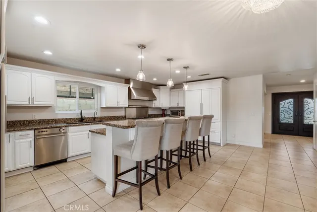 a kitchen with kitchen island wooden cabinets and refrigerator